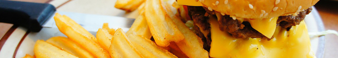 Eating Burger Sandwich at Driftwoods Bar & Grill restaurant in Lihue, HI.